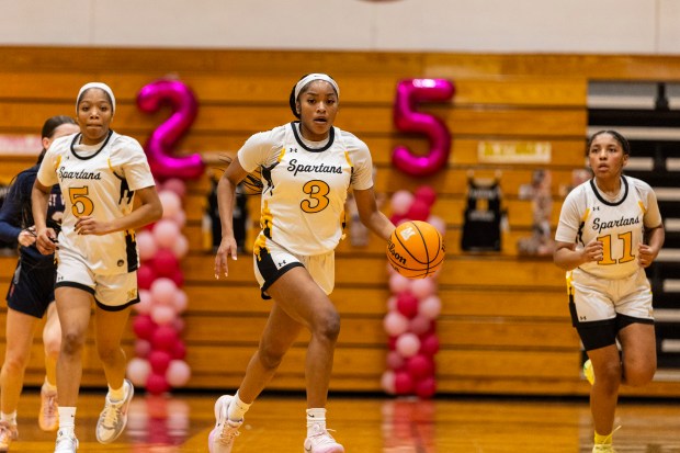 Marian Catholic's Taylor Bolton (3) dribbles with LaParis Poe (5) and Alainna Poisson (11) vs. St. Viator in an East Suburban Catholic Conference game in Chicago Heights on Saturday, Feb. 1, 2025. (Vincent D. Johnson / Daily Southtown)