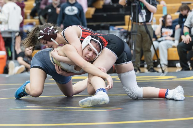 Lemont's Molly O'Connor wrestles Naperville Central's Desi Azar during the 125 pound championship match of the Hinsdale South Regional on Saturday, Feb. 1, 2025. (Troy Stolt / for the Daily Southtown)