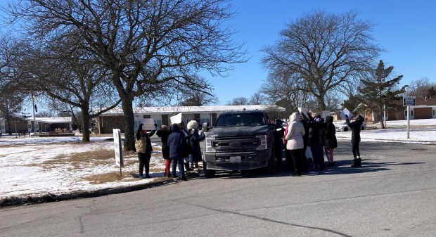 Nurses at the Ludeman Developmental Center in Park Forest surround a tow truck Feb. 21, 2025, in protest of a new parking policy at the center. (Mike Nolan/Daily Southtown)