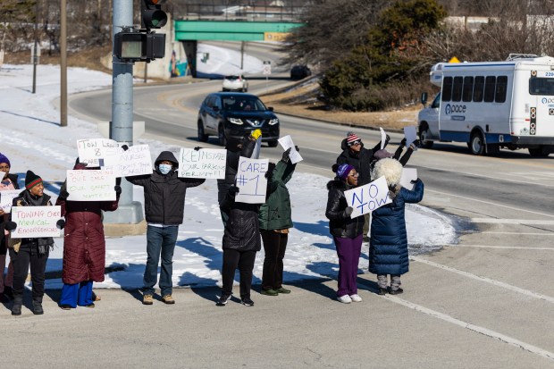 Nurses and workers at the Ludeman Developmental Center protest along Orchard Drive after new parking requirements at the facility has resulted in their cars being towed on Friday, Feb. 21, 2025, in Park Forest. (Vincent D. Johnson / for the Daily Southtown)