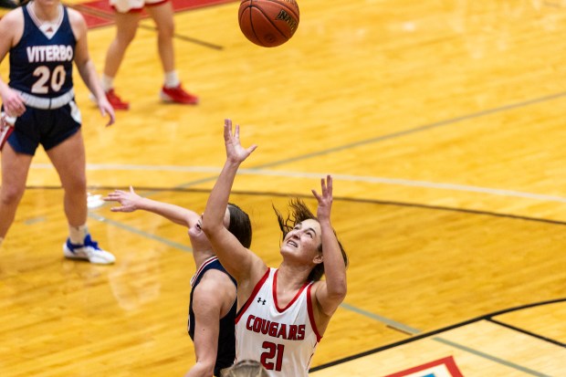 Saint Xavier University's Ryann Ogarek (21) reaches up for a rebound against Viterbo in Chicago on Wednesday, Feb. 5, 2025. (Vincent D. Johnson / for the Daily Southtown)