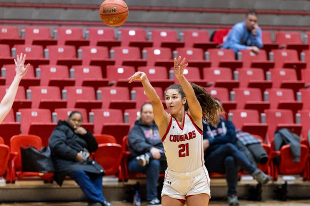 Saint Xavier University's Ryann Ogarek (21) attempts a three pointer against Viterbo in Chicago on Wednesday, Feb. 5, 2025. (Vincent D. Johnson / for the Daily Southtown)