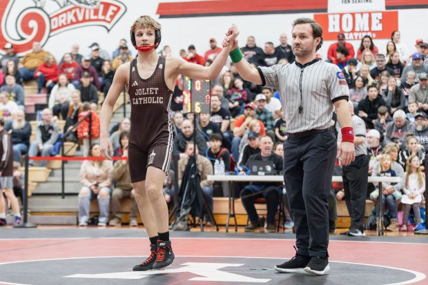 Joliet Catholic's Maddux Tindal has his hand raised after defeating Yorkville's Liam Fenoglio in a 120 pound match during the Class 3A Yorkville Dual Team Sectional in Yorkville on Tuesday, Feb. 25, 2025. (Troy Stolt / for the Daily Southtown)