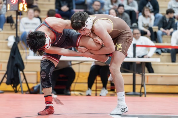 Mount Carmel's Justin Williamson wrestles Marist's Eddie Astorga in a 132 pound match during the Class 3A Yorkville Dual Team Sectional in Yorkville on Tuesday, Feb. 25, 2025. (Troy Stolt / for the Daily Southtown)