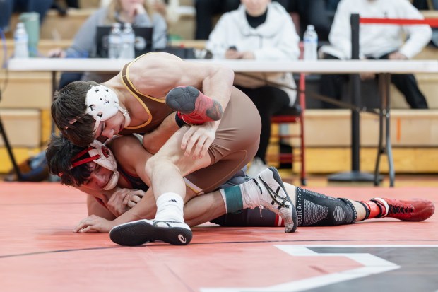 Mount Carmel's Justin Williamson wrestles Marist's Eddie Astorga in a 132 pound match during the Class 3A Yorkville Dual Team Sectional in Yorkville on Tuesday, Feb. 25, 2025. (Troy Stolt / for the Daily Southtown)