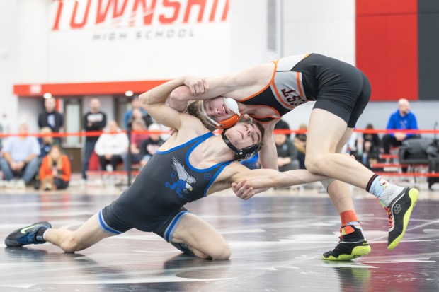 Lincoln-Way East's Tyson Zvonar wrestles Lincoln-Way West's Carter DiBenedetto during the 132 pound championship match of the Class 3A Rich Township Regional in Richton Park on Saturday, Feb. 8, 2025. (Troy Stolt / for the Daily Southtown)