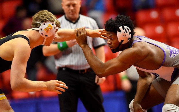 Richard's Mike Taheny (in black) and Plano's Prince Amakiri do a little hand fighting in the 190 pound Class 2A 3rd place match at the IHSA Wrestling individual state meet at the University of Illinois' State Farm Arena in Champaign, Saturday Feb. 22, 2025. (Rob Dicker / for the Daily Southtown)