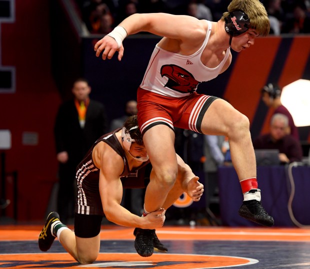 Marist's Ricky Ericksen escapes from Joliet Catholic's Nico Ronchetti in the 190 pound Class 3A 1st place bout at the IHSA Wrestling individual state meet at the University of Illinois' State Farm Arena in Champaign, Saturday Feb. 22, 2025. (Rob Dicker / for the Daily Southtown)