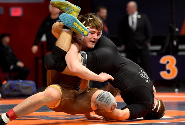 Mt. Carmel's Liam Kelley takes control of Aurora West's Dominic Serio at 157 pounds in the Class 3A 1st place bout at the IHSA Wrestling individual state meet at the University of Illinois' State Farm Arena in Champaign, Saturday Feb. 22, 2025. (Rob Dicker / for the Daily Southtown)