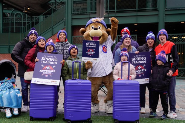 Three Advocate Children's Hospital heart patients, from left, Patricio Leyva, 10, of Country Club Hills, Gerald Kruel, 9, of Chicago, and Mary Alice Kunz, 15, of Bourbonnais, are surprised with a trip to the Chicago Cubs training center in Arizona for spring training, alongside family at Gallagher Way on Feb. 11, 2025. (Audrey Richardson/Chicago Tribune)