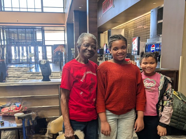 Sharron Davis, from left, stands with her granddaughters Ariana and Anaya Lawton, who helped make the film "Modern Icon," before the Black History Month Film Festival last week at Marcus Cinemas in Country Club Hills. The festival showcased films created by students in District 144. (Janice Neumann/Daily Southtown)