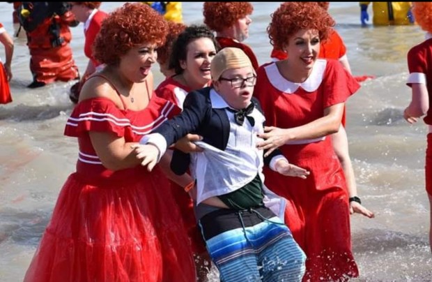 Ebony Carrig, left and two other costumed Kidd's Krue members try to lure Kidd Carrig into Lake Michigan during a past Polar Plunge Chicago. (Carrig family)