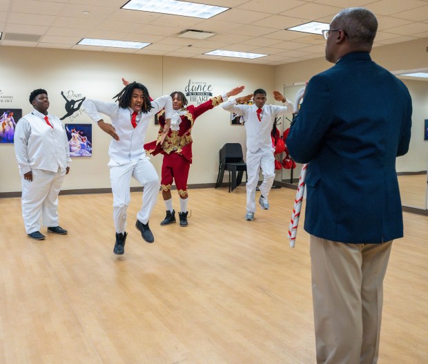 Corey Levy, right, director of operations at Southland College Prep Charter High School and director of the Kappa League program at the school, practices with students for their exhibition performance at the Kappa League Step Show on Saturday, Feb. 15, 2025, in Richton Park. (Eric Lites)