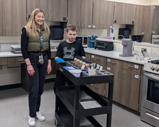 Stagg High School teacher Carrie Majchrowicz and ULTIMA program student Luke Carroll prepare to get Charlie Chargers Coffee Cart rolling on a recent morning at the school in Palos Hills. The student-run operation sells coffee to staff while providing students with life skills. (Janice Neumann/Daily Southtown)