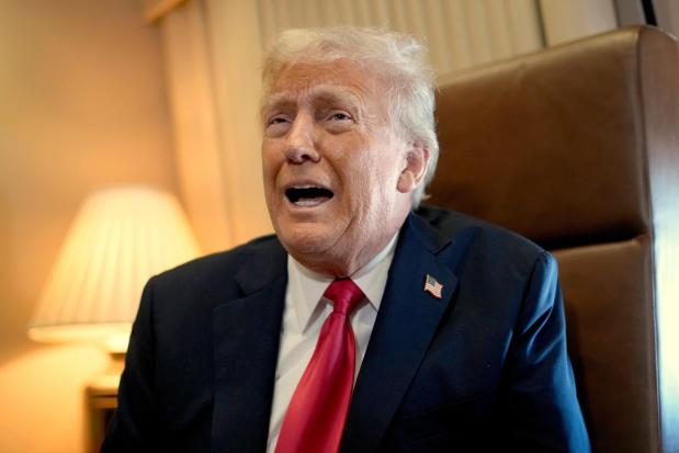 President Donald Trump speaks to reporters aboard Air Force One where he signed a proclamation declaring Feb. 9 Gulf of America Day as he travels from West Palm Beach, Fla. to New Orleans, Sunday, Feb. 9, 2025. (AP Photo/Ben Curtis)