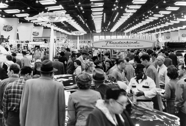 Visitors view new car displays at the 53rd Chicago Auto Show at McCormick Place on Feb. 25, 1961, in Chicago. (Leonard Bartholomew/Chicago Tribune) 