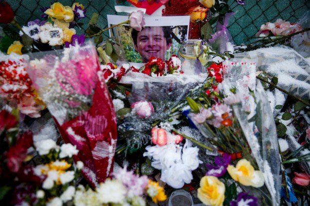 Flowers sit around a memorial for Trevor Wehner outside the Henry Pratt Co. plant where Friday Wehner and six people, including the gunman, were fatally shot on Feb. 17, 2019, in Aurora. (Armando L. Sanchez/Chicago Tribune)