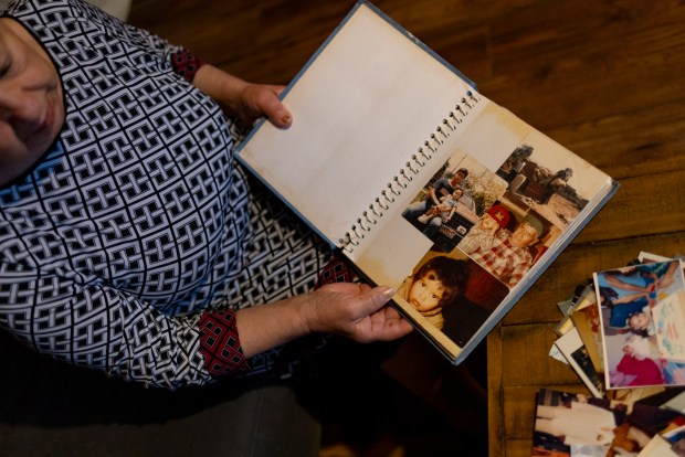 Maria talks about her son, Erick, who was deported to Mexico years ago, while looking at their family photos on Jan. 28, 2025, at their home in Little Village. (Brian Cassella/Chicago Tribune)