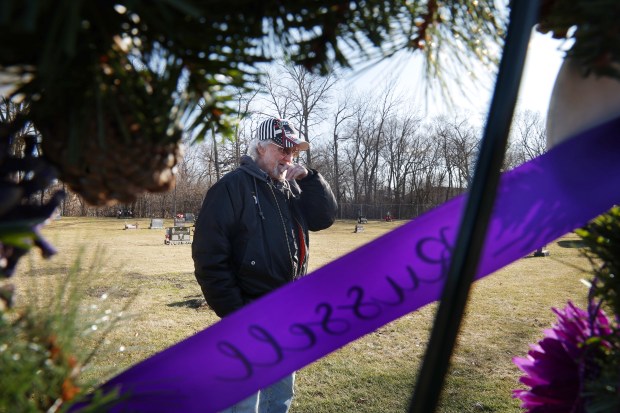 Ted Beyer visits the grave of his son, Russell Beyer, on Feb.13, 2024, in Mount Olive Catholic Cemetery in Aurora. Russell was one of five victims in the Henry Pratt mass shooting on Feb. 15, 2019. (Stacey Wescott/Chicago Tribune)