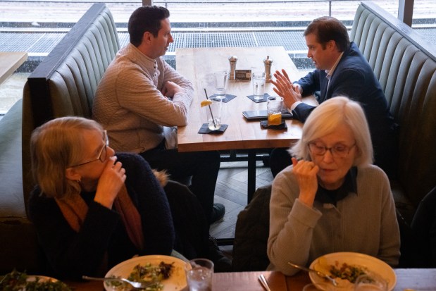 Michael Cooney, top left, and Matthew Jenkins enjoy their lunch break at The Dearborn in Chicago on Feb. 12, 2025. (Audrey Richardson/Chicago Tribune)