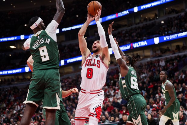 Milwaukee Bucks forward Bobby Portis (9) guards Chicago Bulls guard Zach LaVine (8) while he goes up for a shot during the first period at the United Center Monday Dec. 23, 2024, in Chicago. (Armando L. Sanchez/Chicago Tribune)