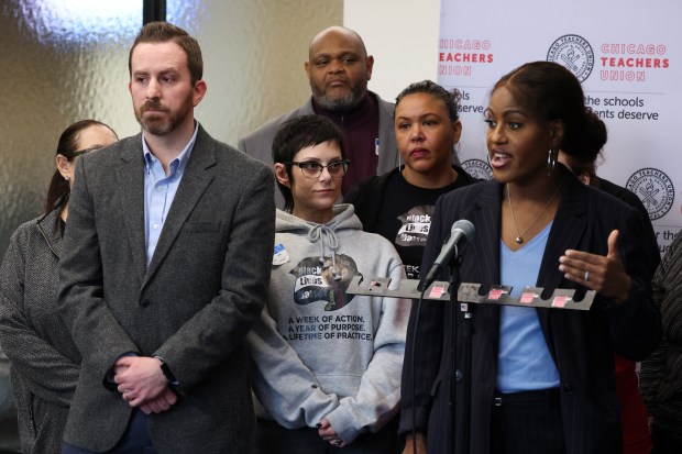 Chicago Teachers Union (CTU) Deputy General Counsel Thad Goodchild, left, listens as CTU President Stacy Davis Gates, right, talks about recommendations from the "fact-finding" process in a press conference at CTU headquarters on Feb. 5, 2025. (Terrence Antonio James/Chicago Tribune)