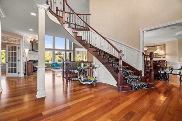 This Mokena home at 12201 Maggies Way has landscaped grounds, a pool, a brick paver patio, Trex decking, a fire pit and a private pond with a fountain. (Bryan and Jackie Badillo/Manor Images)