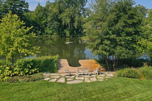 This seven-bedroom home at 35 Indian Hill Road in Winnetka has a fountain, a swimming pool and a spring-fed lake. (Joe Compean/VHT)