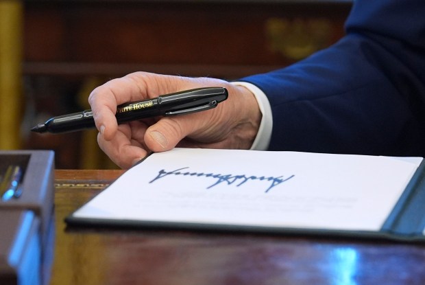 President Donald Trump signs executive orders in the Oval Office of the White House, Feb. 4, 2025. (Evan Vucci/AP)