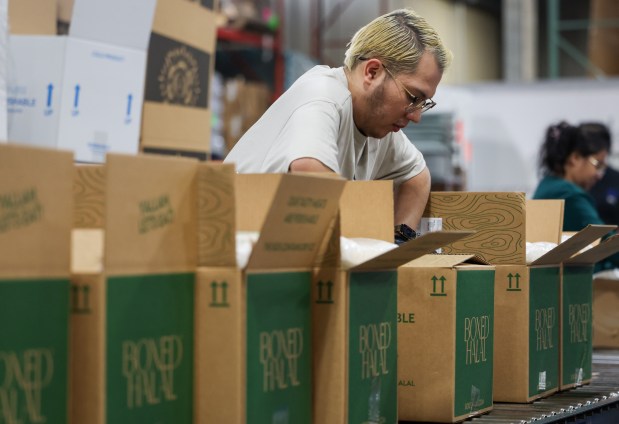 Ruben Alarcon packages Boxed Halal, a subscription-based halal meat delivery service, at the their warehouse in Wheeling on Feb. 4, 2025. (Audrey Richardson/Chicago Tribune)