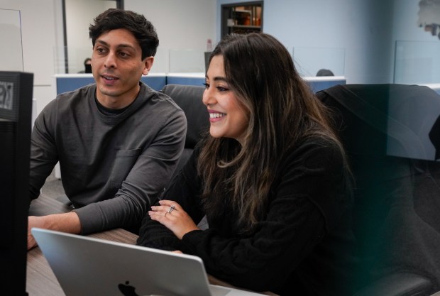 Owners of 786 Cosmetics Ibrahim Ali, left, and his wife, Iqra Isphahani, discuss Valentine's Day marketing at their headquarters at Invent Inc. in Schaumburg on Feb. 6, 2025. (Audrey Richardson/Chicago Tribune)