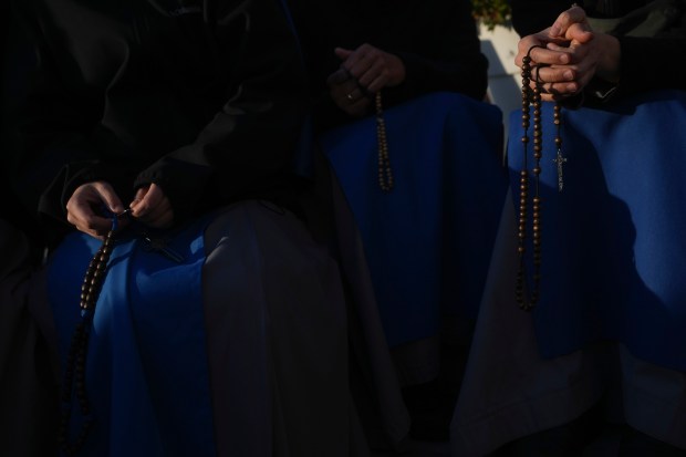 Nuns pray for Pope Francis in front of the Agostino Gemelli Polyclinic, in Rome, Saturday, Feb. 22, 2025, where the Pontiff is hospitalized since Friday, Feb. 14.(AP Photo/Alessandra Tarantino)