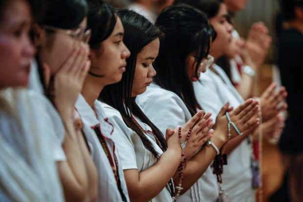 Catholic faithful gather at the Immaculate Conception Cathedral popularly known as the Manila Cathedral in Manila, Philippines on Feb. 21, 2025 to pray for the healing and recovery of Pope Francis as part of a nationwide call for prayers initiated by the Catholic Bishop's Conference of the Philippines. (Gerard Carreon/AP)