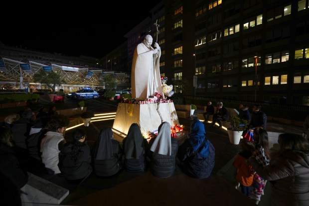 People pray for Pope Francis in front of the Agostino Gemelli Polyclinic, in Rome on Feb. 23, 2025, where the Pontiff is hospitalized since Friday, Feb. 14. (Andrew Medichini/AP)