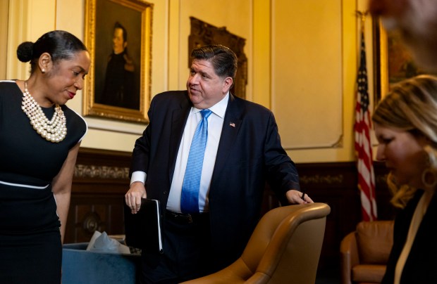 Gov. JB Pritzker departs with Lt. Gov. Juliana Stratton after speaking from his ceremonial office Feb. 19, 2025, at the Illinois Capitol building in Springfield. (Brian Cassella/Chicago Tribune)