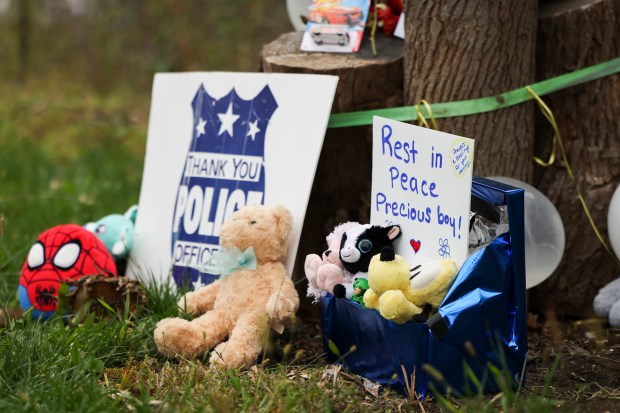 Items are displayed at the corner of South Lincoln Highway and Lily Cache Road in memorial of Wadee Alfayoumi near his Plainfield Township home on Oct. 16, 2023. (Eileen T. Meslar/Chicago Tribune)