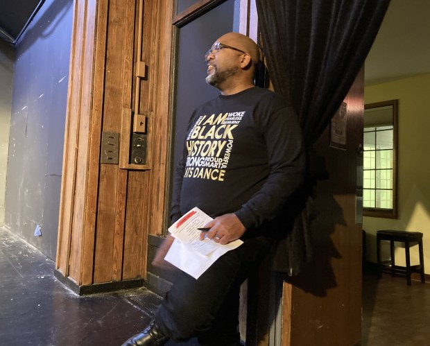 Narrator Cory Ratliff watches one of the performers from the wings. (Steve Sadin/For the Lake County News-Sun)