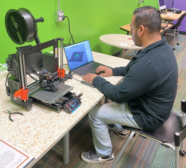 Library IT Director Isaac Salgado operates a 3D printer in the maker space.  (Steve Sadin/For the Lake County News-Sun)