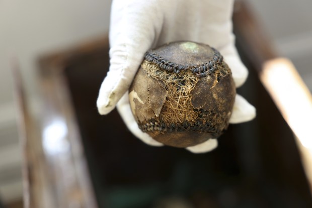 Restauranteur Grant DePorter holds a baseball from the 1919 World Series at Tribune Tower Residences on Aug. 24, 2022.