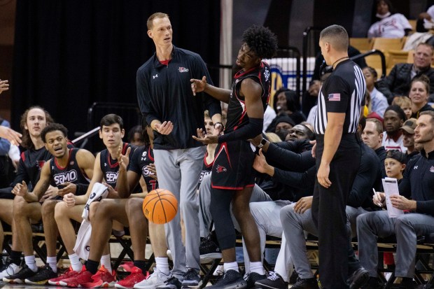 Southeast Missouri State's Israel Barnes, second from front right, dribbles into coach Brad Korn, front left, in front of the bench during the second half of a game at Missouri on Sunday, Dec. 4, 2022.