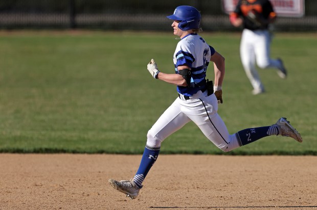 St. Charles North's Keaton Reinke (6) sprints to third on a triple in the third inning during a DuKane Conference game against Batavia on Monday, April 15, 2024 in St. Charles.H. Rick Bamman / For the Beacon-News