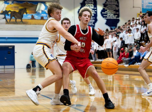 West Aurora's Kael Adkins (10) dribbles the ball around Downers Grove North at the Class 4A Downers Grove South Regional final in Downers Grove on Friday, Feb. 28, 2025. (Nate Swanson/for the Beacon-News)