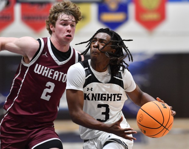 Kaneland's Marshawn Cocroft (3) drives to the basket as Wheaton Academy's Tyler Smith defends during the Class 3A IMSA Regional championship game on Friday, Feb. 28, 2025 in Aurora...(Jon Cunningham/for The Beacon-News)