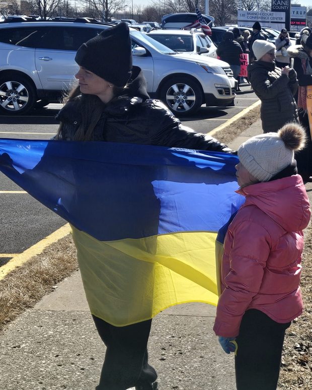 A Ukrainian flag is displayed Saturday during a protest rally along South Randall Road in St. Charles. (David Sharos / For The Beacon-News)