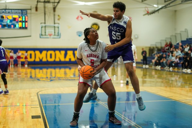 Aurora Christian's Jordan Weeks (5) plays the ball in the post against North Shore Country Day's Emeka Ogbolumani (55) during a Class 1A Somonauk Sectional semifinal basketball game at Somonauk High School on Tuesday, March 4, 2025. (Sean King / for The Beacon-News)