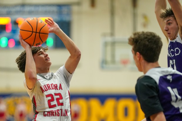 Aurora Christian's Jacob Baumann (22) shoots the ball in the post against North Shore Country Day's Gerald Kalotis (right),during a Class 1A Somonauk Sectional semifinal basketball game at Somonauk High School on Tuesday, March 4, 2025. (Sean King / for The Beacon-News)