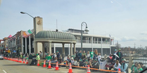 People line the route for the St. Patrick's Parade in St. Charles on Saturday. (David Sharos / For The Beacon-News)