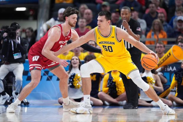 Michigan's Vladislav Goldin drives on Wisconsin's Carter Gilmore during the second half of the Big Ten Tournament on March 16, 2025. (AP Photo/Michael Conroy)