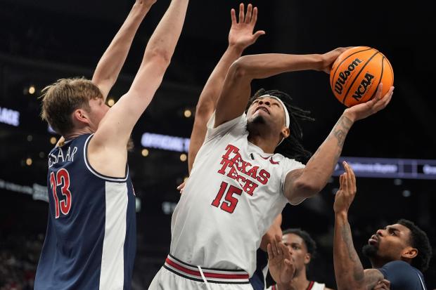 Texas Tech's JT Toppin shoots over Arizona's Henri Veesaar (13) during the second half of the Big 12 Tournament on March 14, 2025, in Kansas City, Mo. (AP Photo/Charlie Riedel)