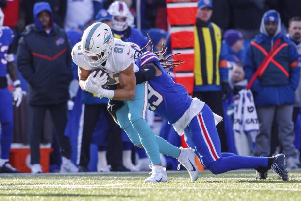 Dolphins tight end Durham Smythe is tackled by Bills linebacker Tremaine Edmunds during a wild-card game on Jan. 15, 2023, in Orchard Park, NY. (AP Photo/Matt Durisko)